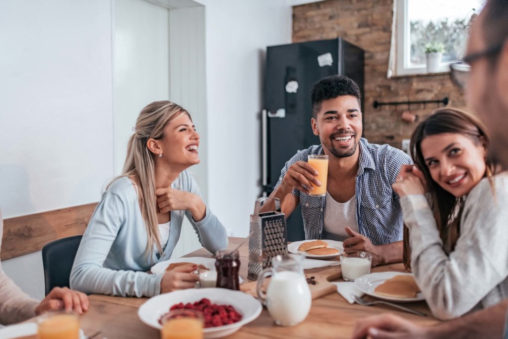 Group of people having breakfast at a transitional housing facility