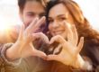 couple making heart hands having a sober valentines day