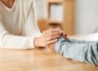 couple holding hands across table learning about addiction recovery tools